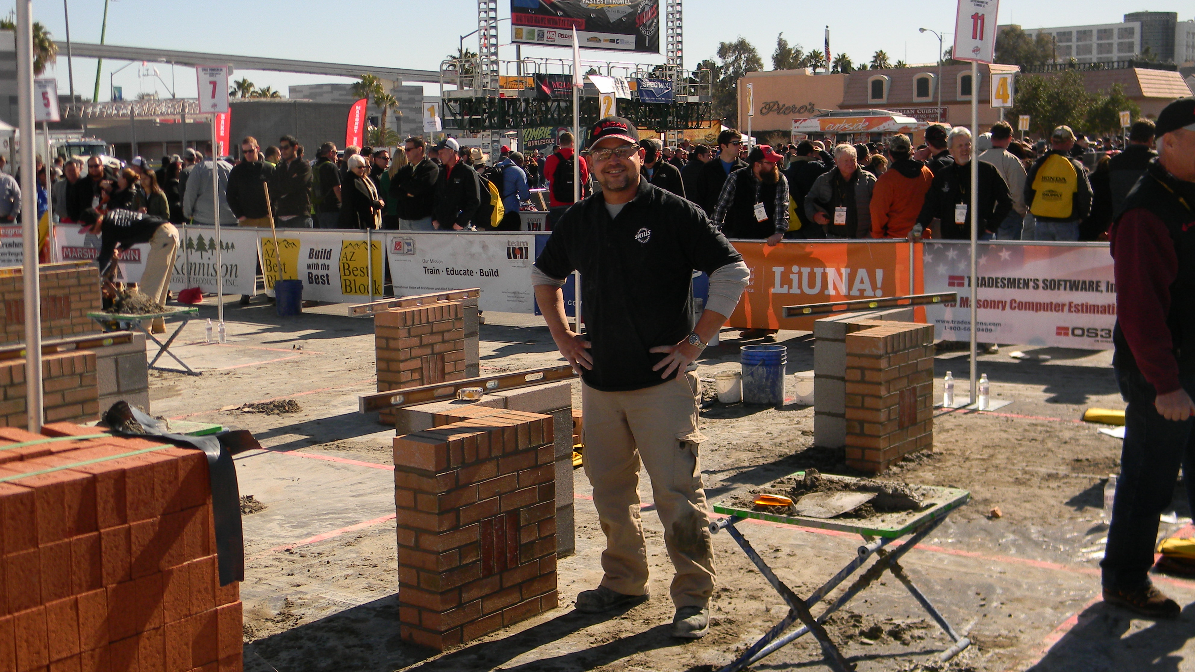 Ken Hernandez stands by his wall corner built during the competition.